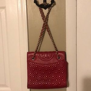 Red Tory Burch purse with gold chain.  Some  wear.